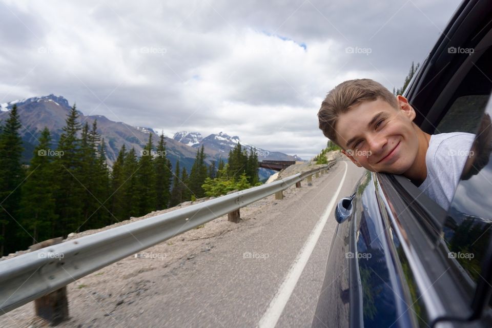 Happiness is ... my son sticking his head out of the hire car as I try to capture a picture of the Columbia Icefield Skywalk 😂