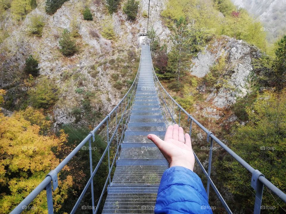 male hand can be seen on the Tibetan bridge