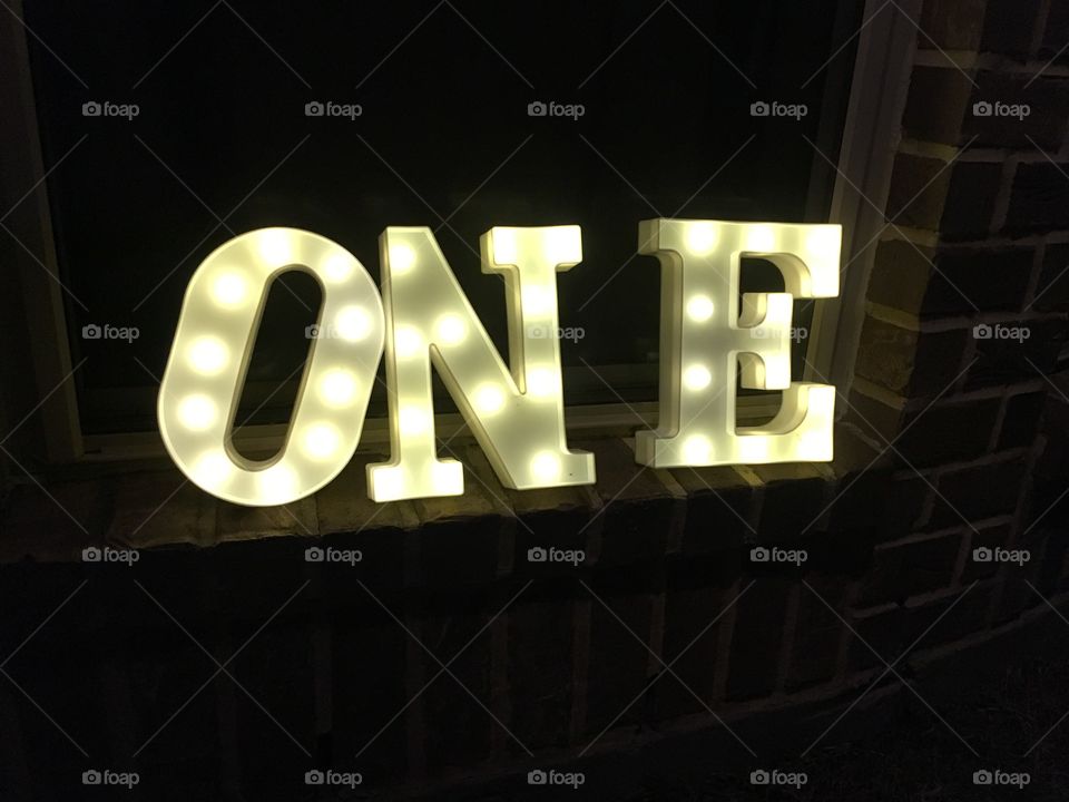 Lighted letters spelling one