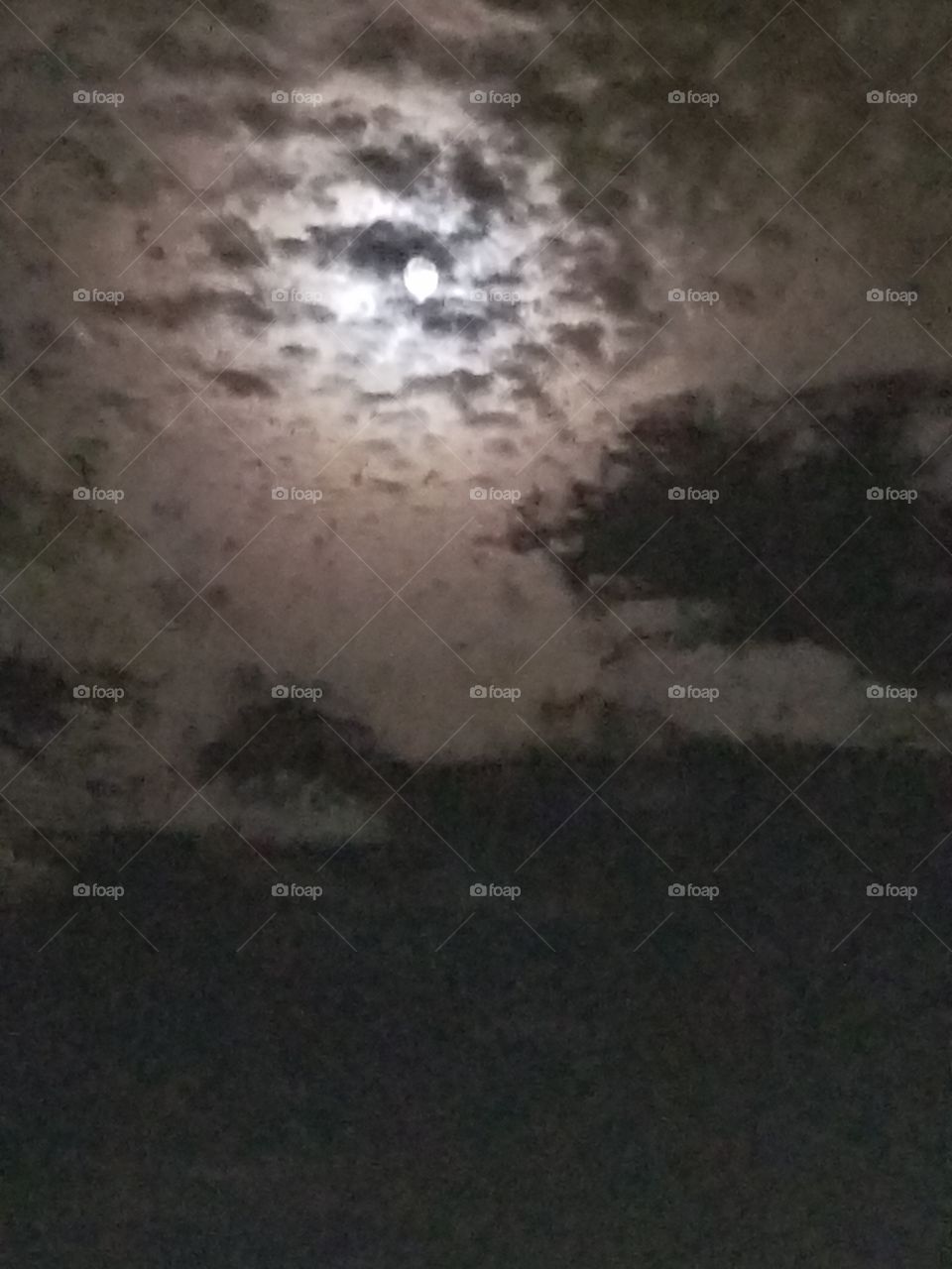 Super moon in the cloudy sky over Texas