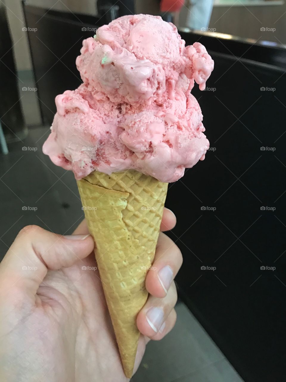 Pink strawberry ice-cone in a waffle cone