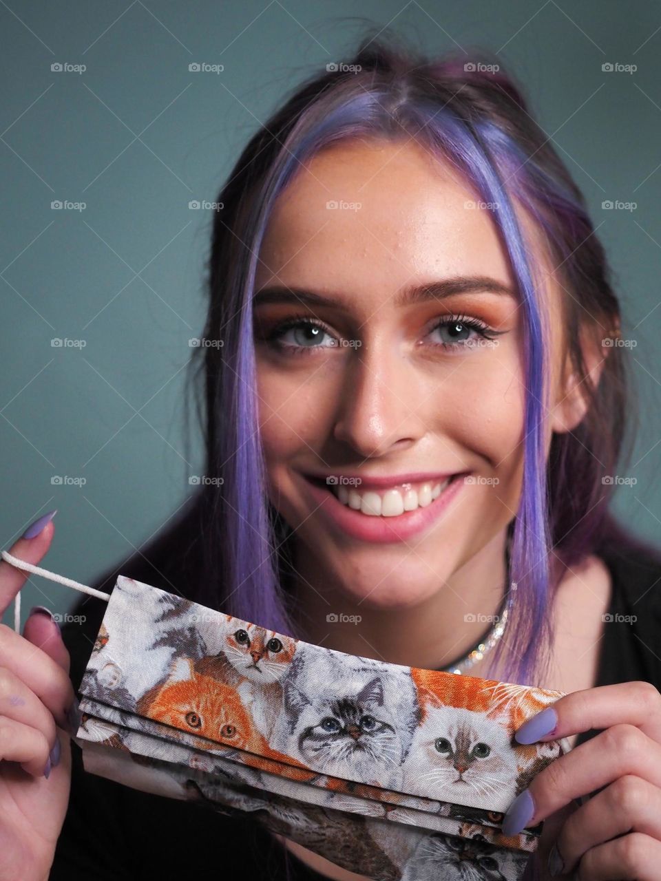 Pretty girl holding handmade cotton facemask