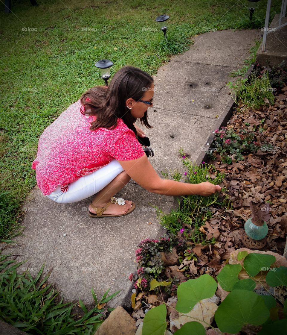 My wife working in the flower bed