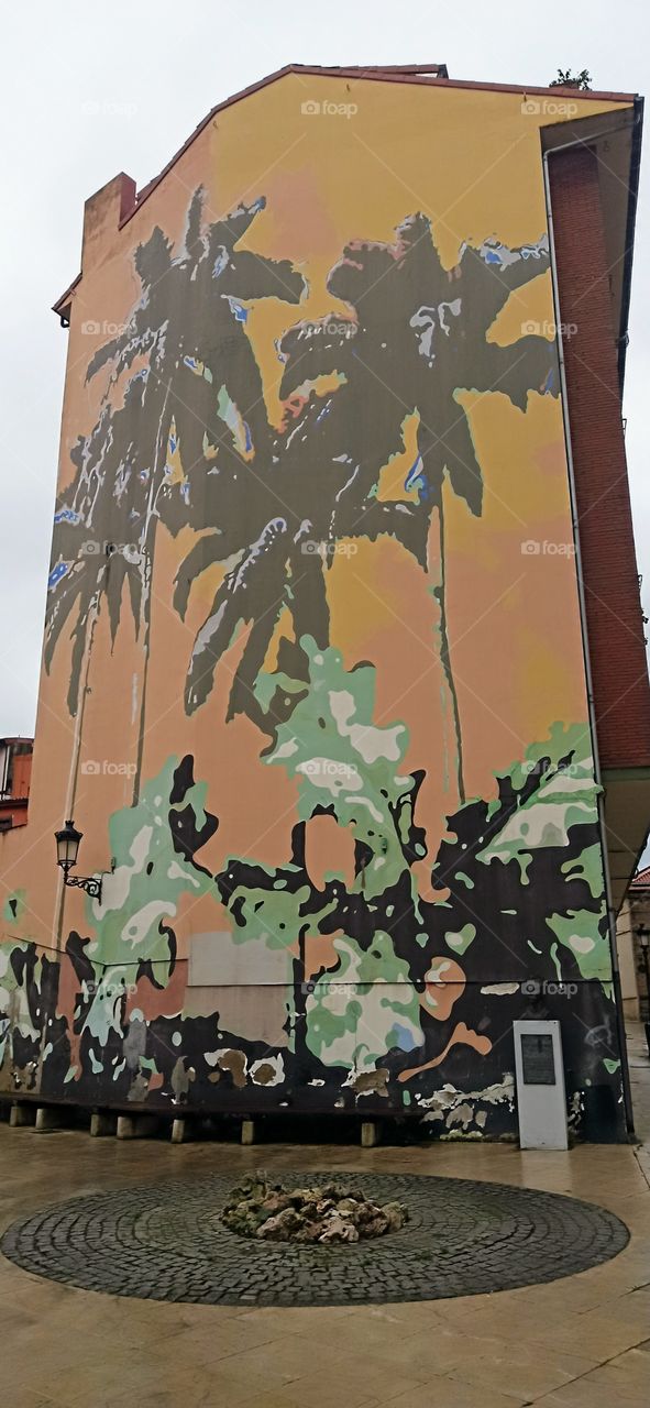 background of palm trees painted on a facade