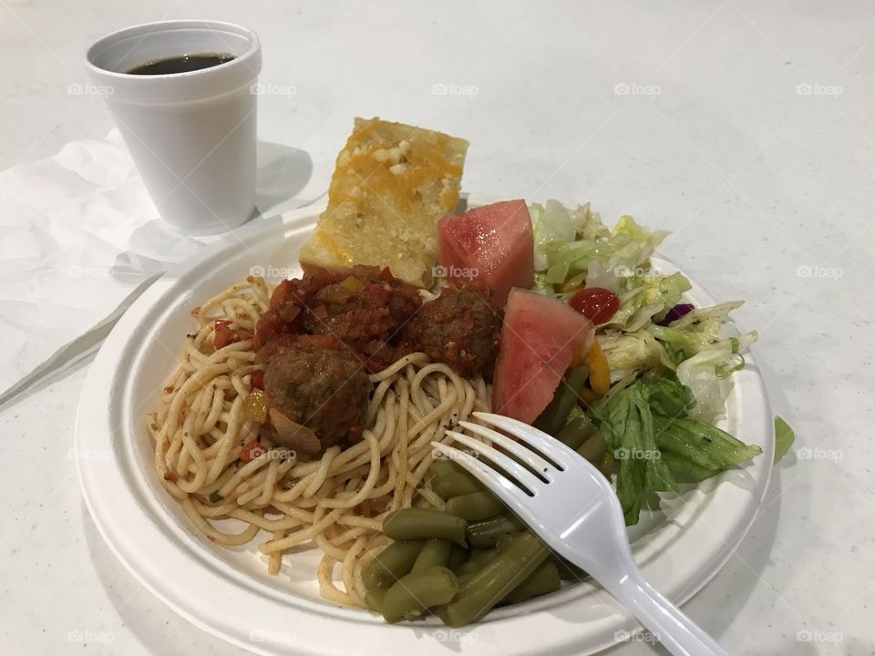 A simple black coffee with spaghetti dinner. There is nothing like drinking healthy beverage like coffee while consuming spaghetti and other edibles for pleasure. Coffee consumption itself does have its personal satisfaction.