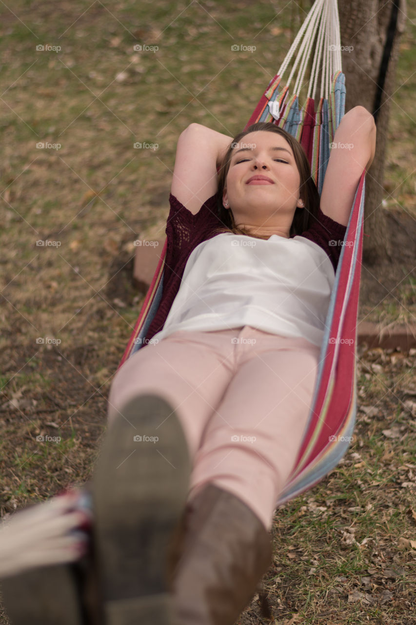 Woman relaxing in a hammock. 