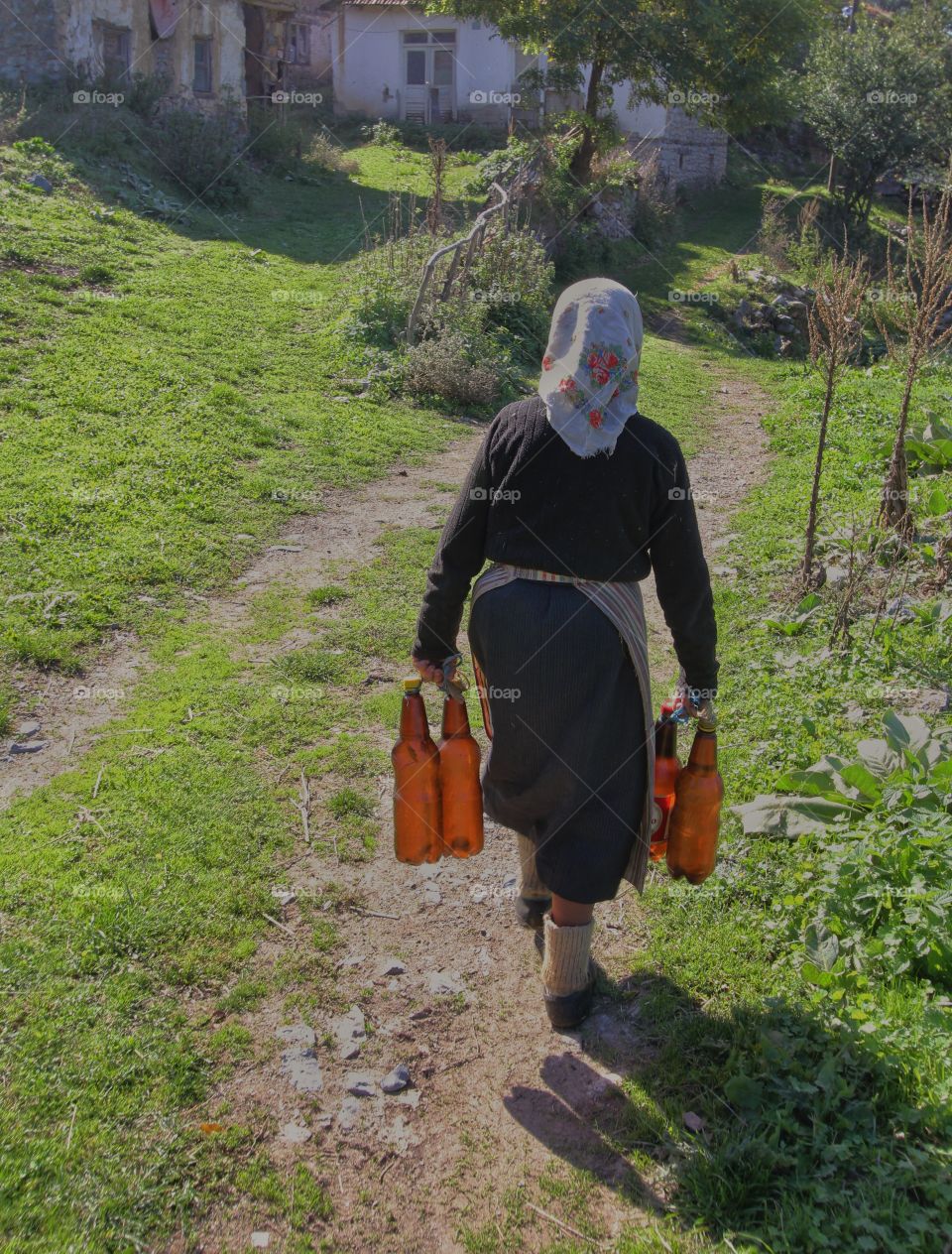 Woman in small Macedonian village going to get water every morning 
