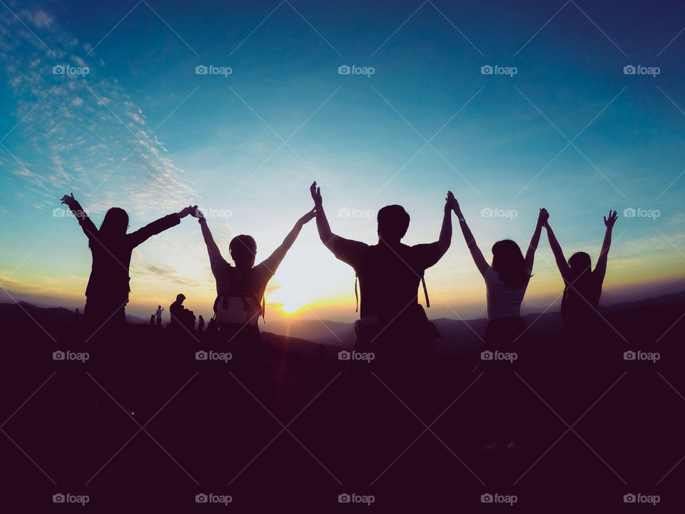 Silhouette of people with a beautiful landscape in the sunset