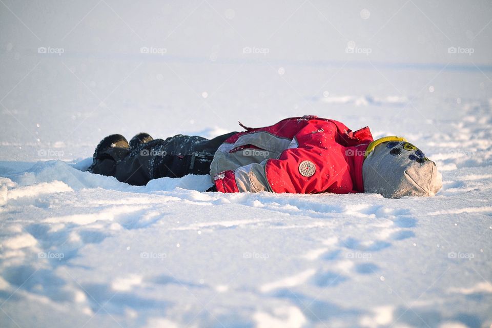 Boy doing a snowangel