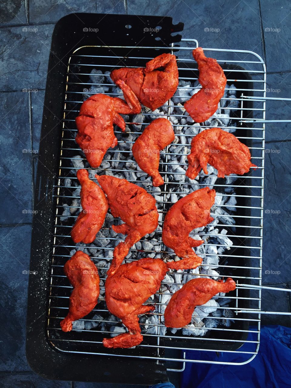 Directly above shot of chicken cooking in barbeque