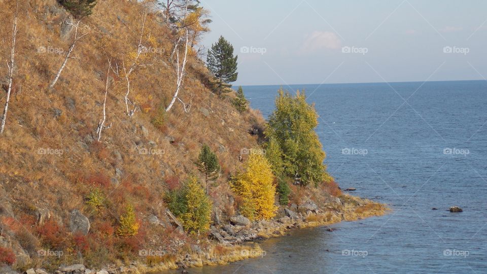 Autumn on the shores of lake Baikal. Eastern slope of the southern part of the Primorsky ridge.