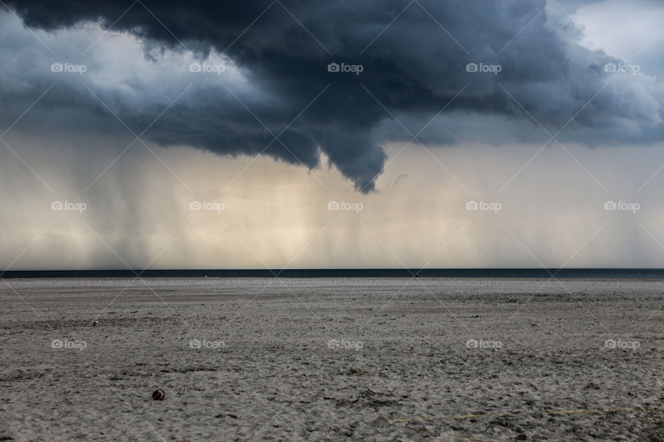 Scenic view of beach against cloudscape