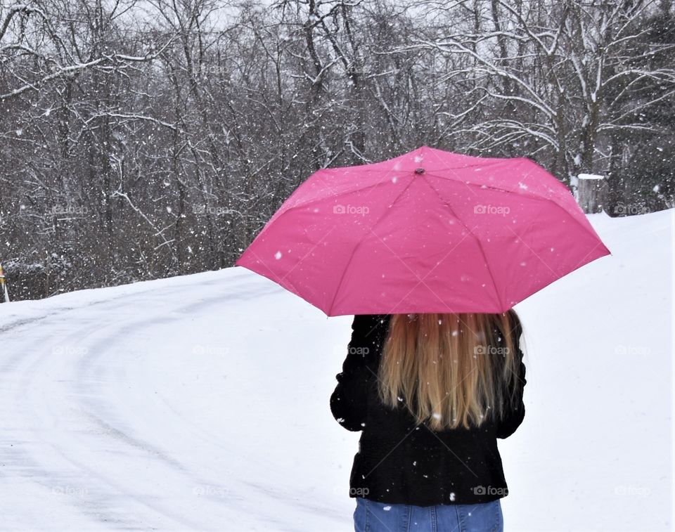 Totes pink umbrella, woman in a snow storm 