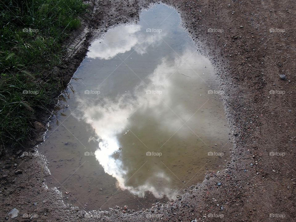 Sky reflection on the puddle