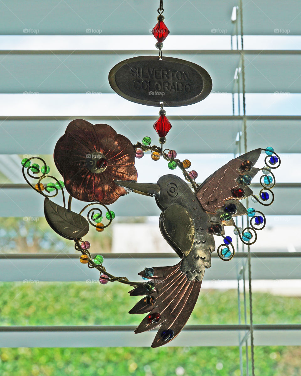 Metal hummingbird and bead hanging