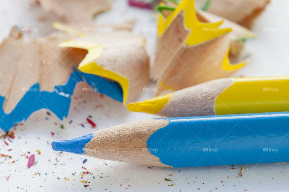 Close-up of yellow and blue colored pencils