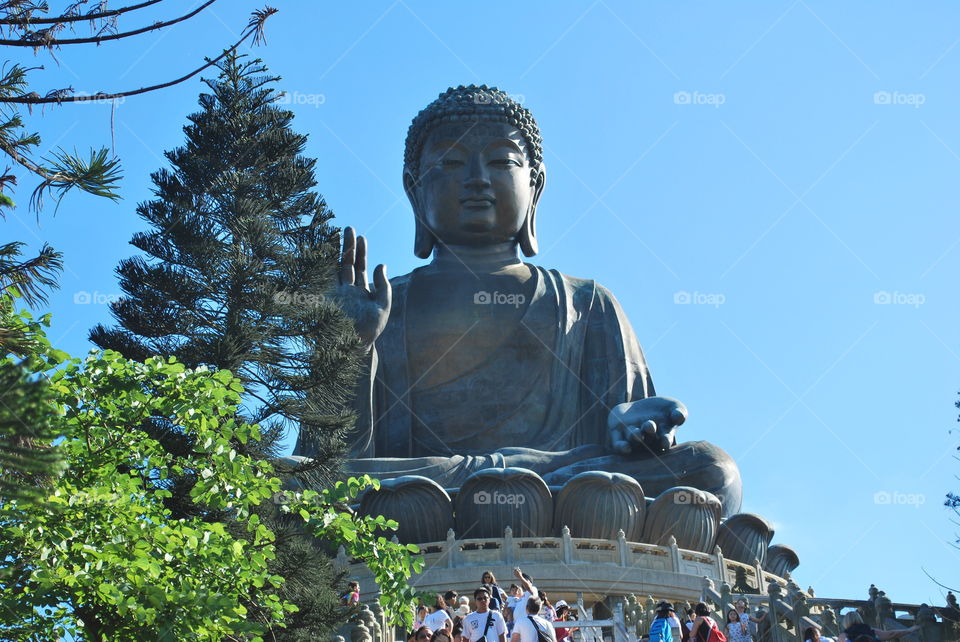 This is Tian Tan Buddha also known as the Big Buddha, is a large bronze statue of Buddha Shakyamuni, located at Ngong Ping, Lantau Island, in Hong Kong. The statue is sited near Po Lin Monastery and symbolises the harmonious relationship between man and nature, people and faith. It is a major centre of Buddhism in Hong Kong, and is also a popular tourist attraction. This picture was taken in June/19/2015  with the same camera that i had while me and my family were visiting this place .