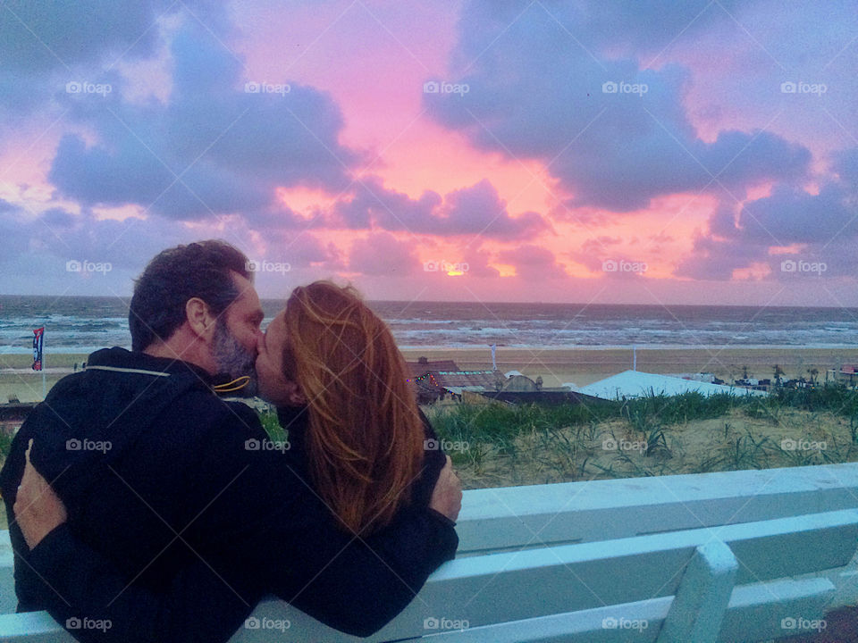 Rear view of a mature couple kissing during sunset