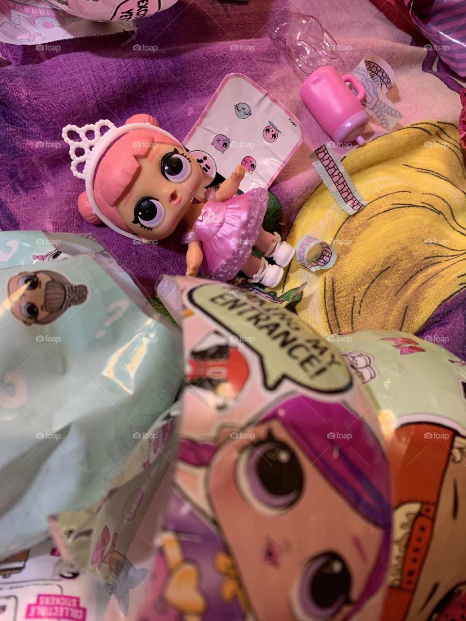 in the ball with a surprise was a beautiful doll in a pink dress with a tiara on her head