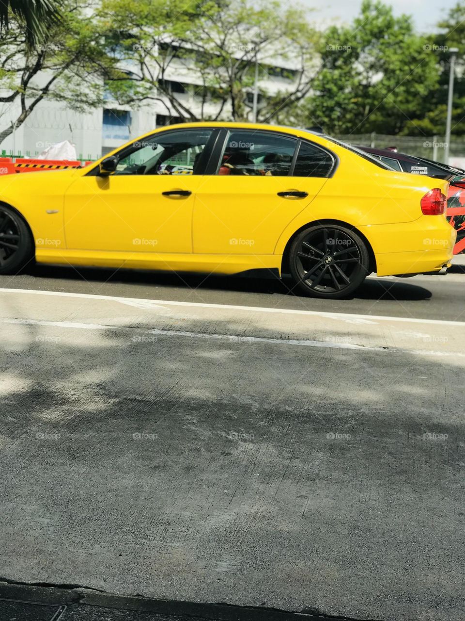 The yellow car on her way on the road 