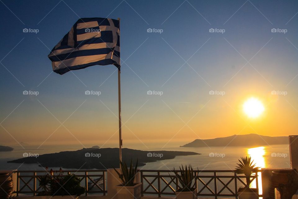 Greece. Greek flag flying in the wind on Santorini.