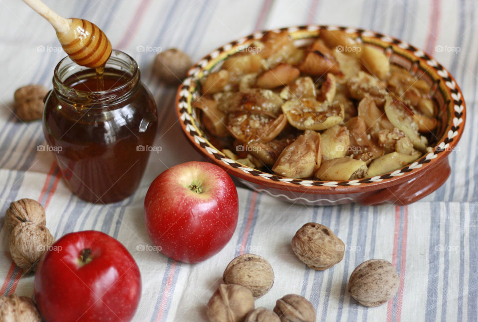 Baked apples, honey, walnuts, rustic stkll life