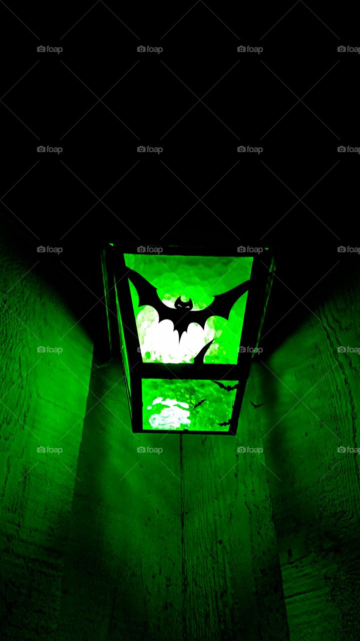 Green porch light & black bat