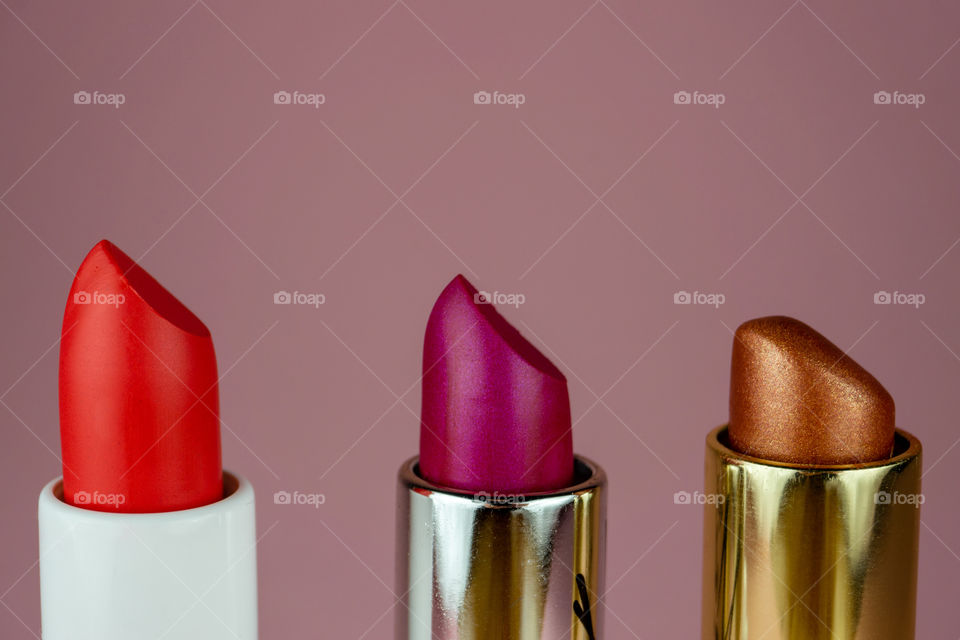 Colorful lipstics close up. Creative beauty concept