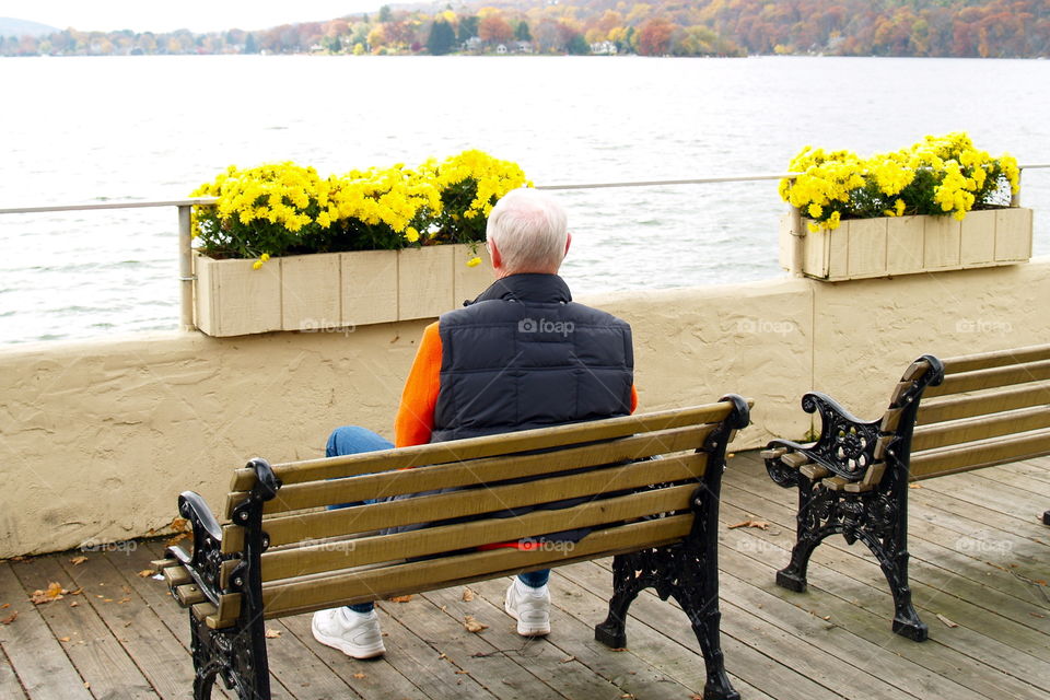 Sitting on park bench looking at lake