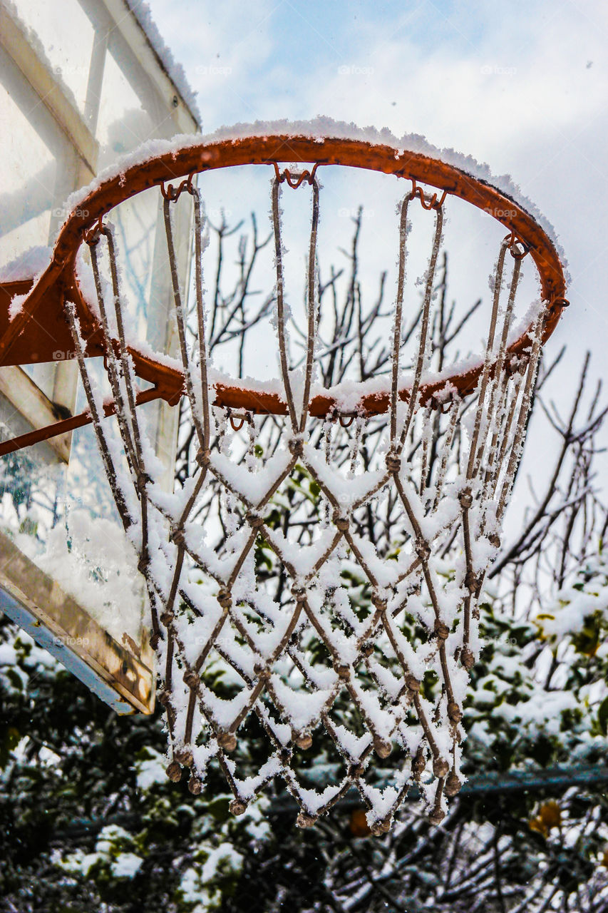 Snow covered on basketball hoop