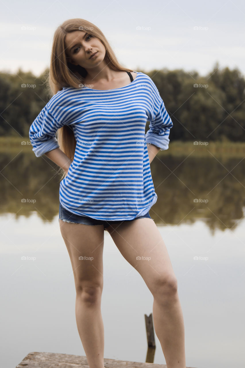 A girl with blond hair on the lake in a striped shirt and short denim shorts on the background of grass, reeds and an old wooden boat
Girl, woman, people, blonde, blonde hair, striped shirt, short shorts, denim shorts, shore, lake, grass, reeds, old boat, feelings, emotions, tenderness, love, lifestyle, lifestyle, vacation