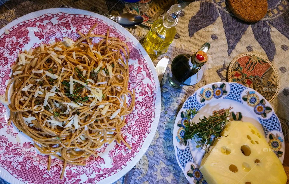 high angle view of spaghetti with olive oil, cheese and thyme