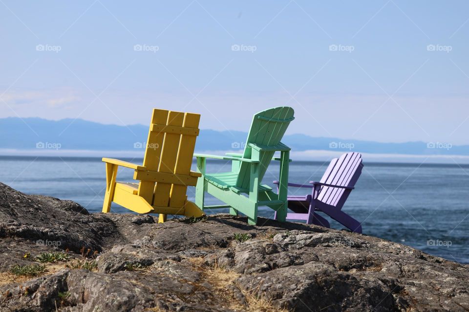 Lounge chairs on a rocky shore 