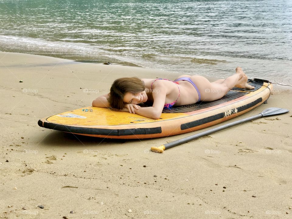 Girl lying on a surfboard Stand up paddle