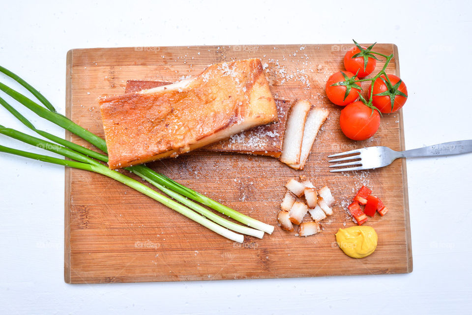 Bacon with fresh vegetable on chopping board