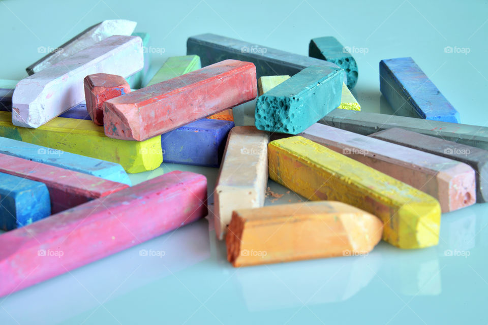 Colorful chalk over blue background