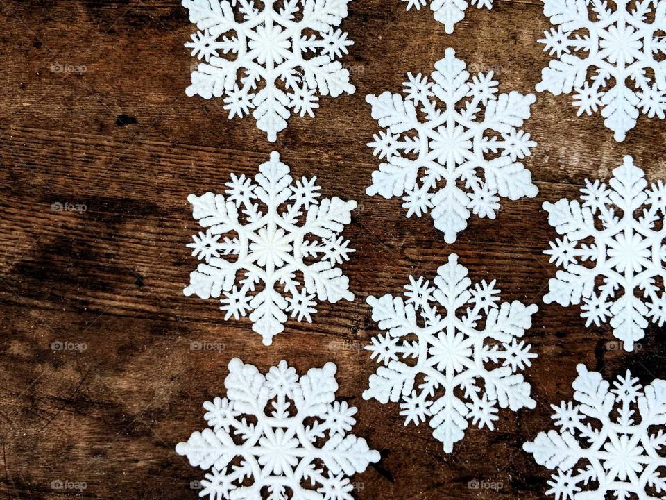 snowflakes arranged on a wooden table