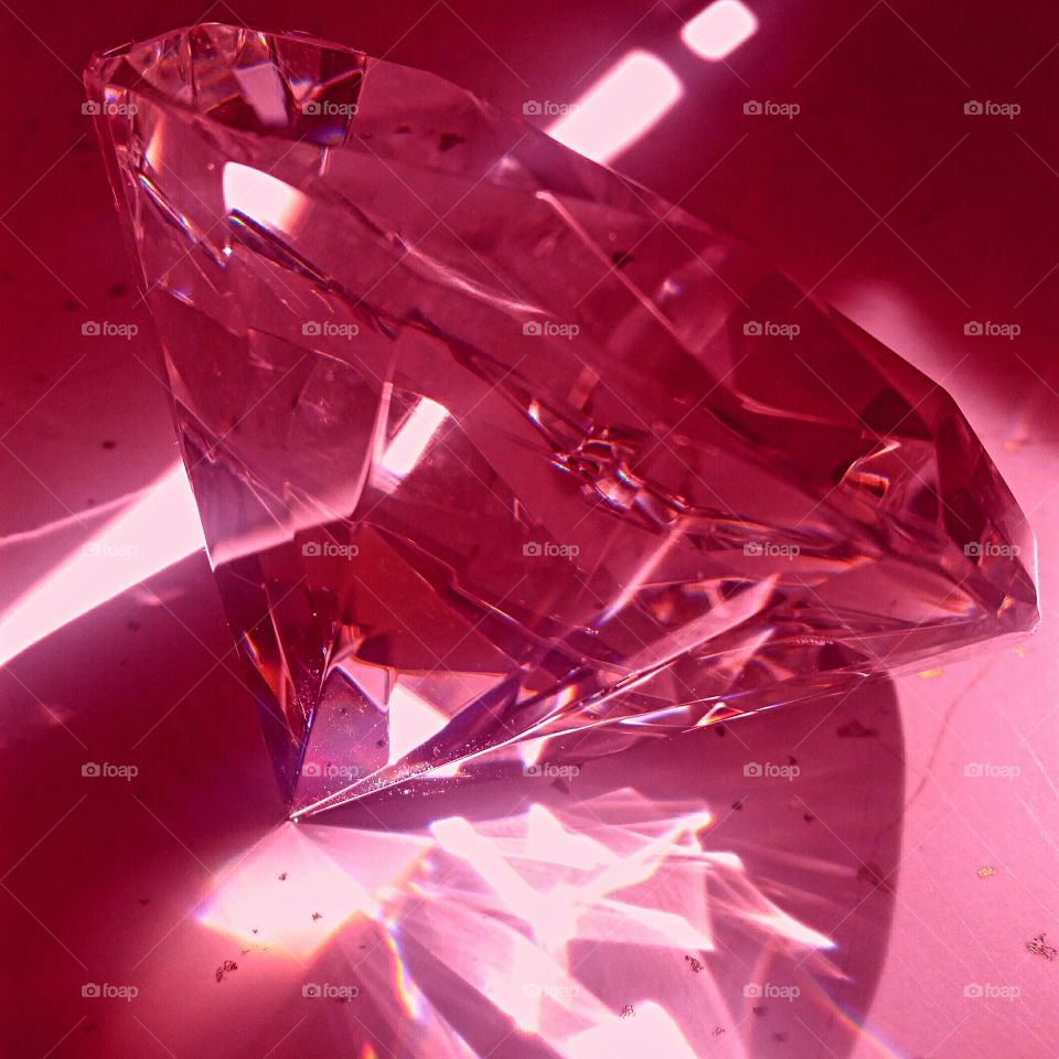 Sunlight reflecting through a pink crystal paperweight!