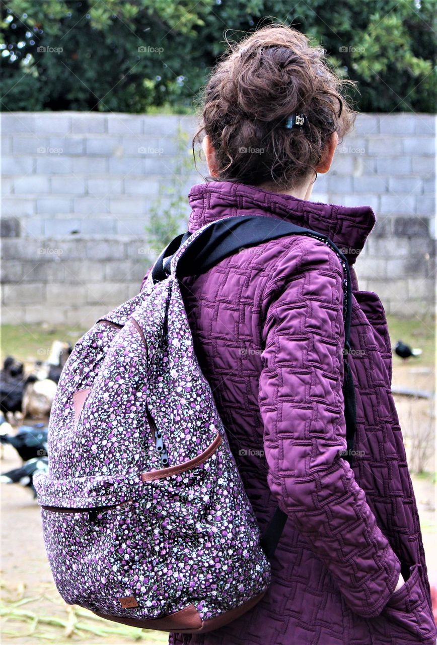 a girl was watching the ducks on a farm in the North of Iran