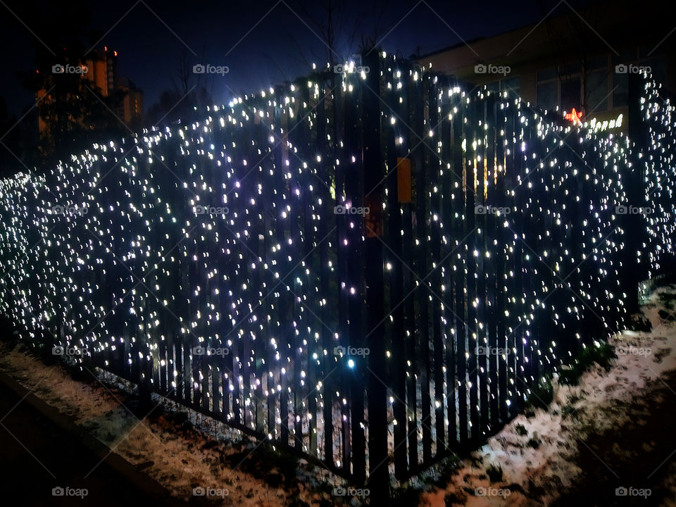 Preparing for the New Year.  Garland on the fence