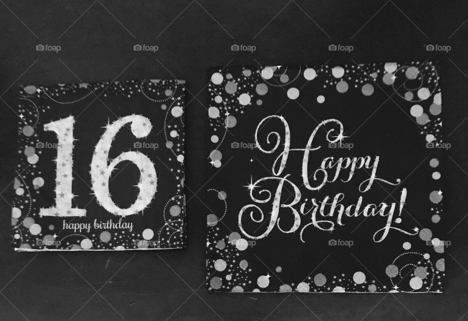 A display of happy birthday napkins black-and-white photo, sweet 16 birthday party. USA, America