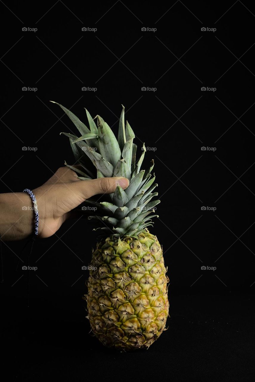 Pineapple on black background. Tropical fruit