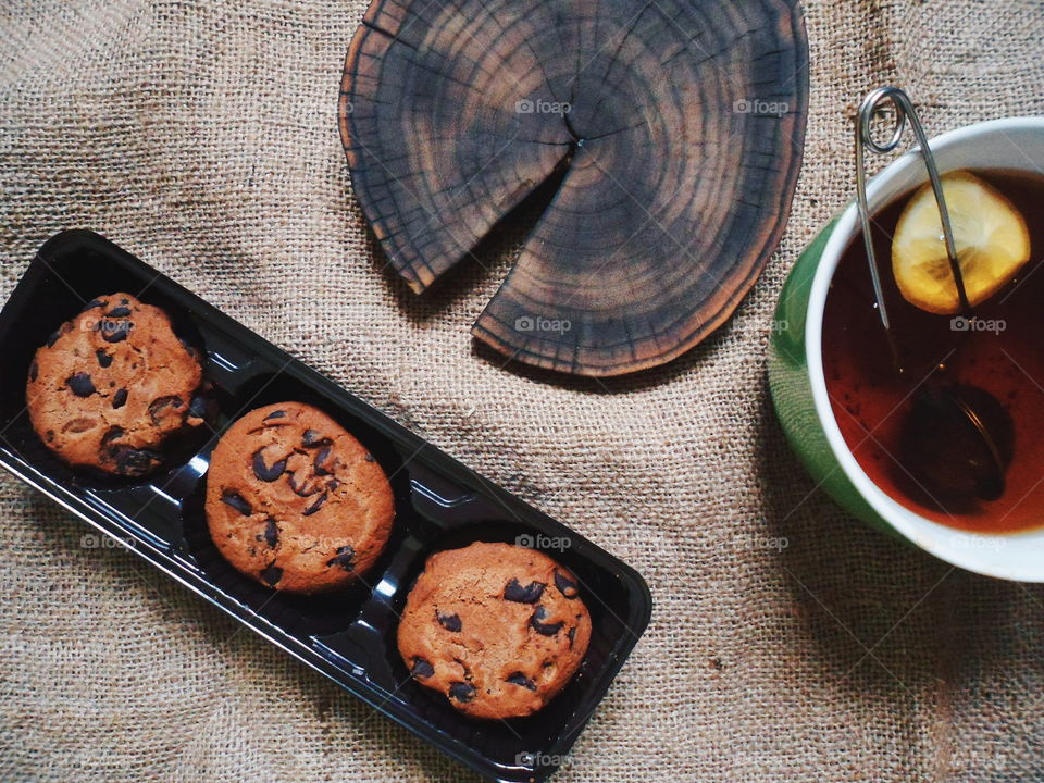 oatmeal cookies with chunks of chocolate and a cup of tea, dessert