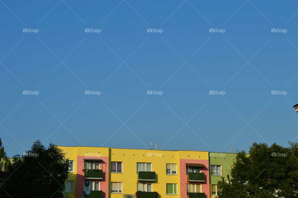 clear blue sky above colored buildings in Poland