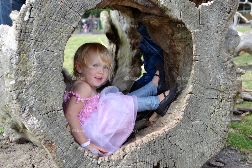 Little girl of two years old playing in the park in Knutenborg Zoo in Denmark.