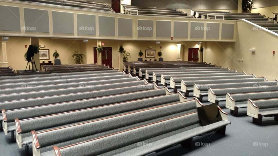 Empty pews in an empty church auditorium