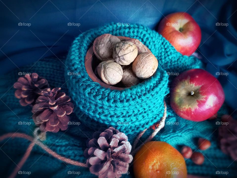nuts and apples with a green sweater.