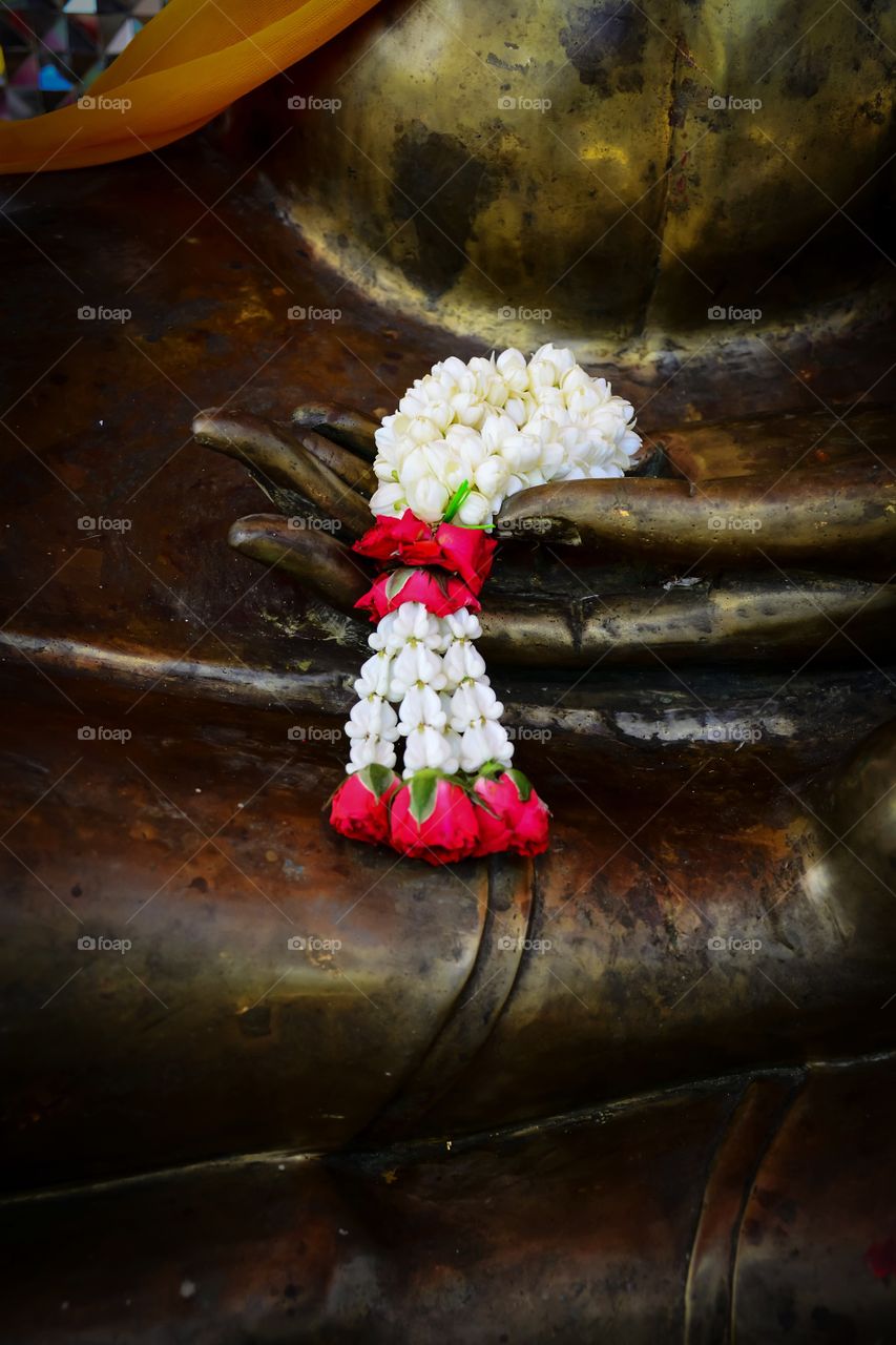 Beautiful white flowers garland on the Buddha in the Thai temple