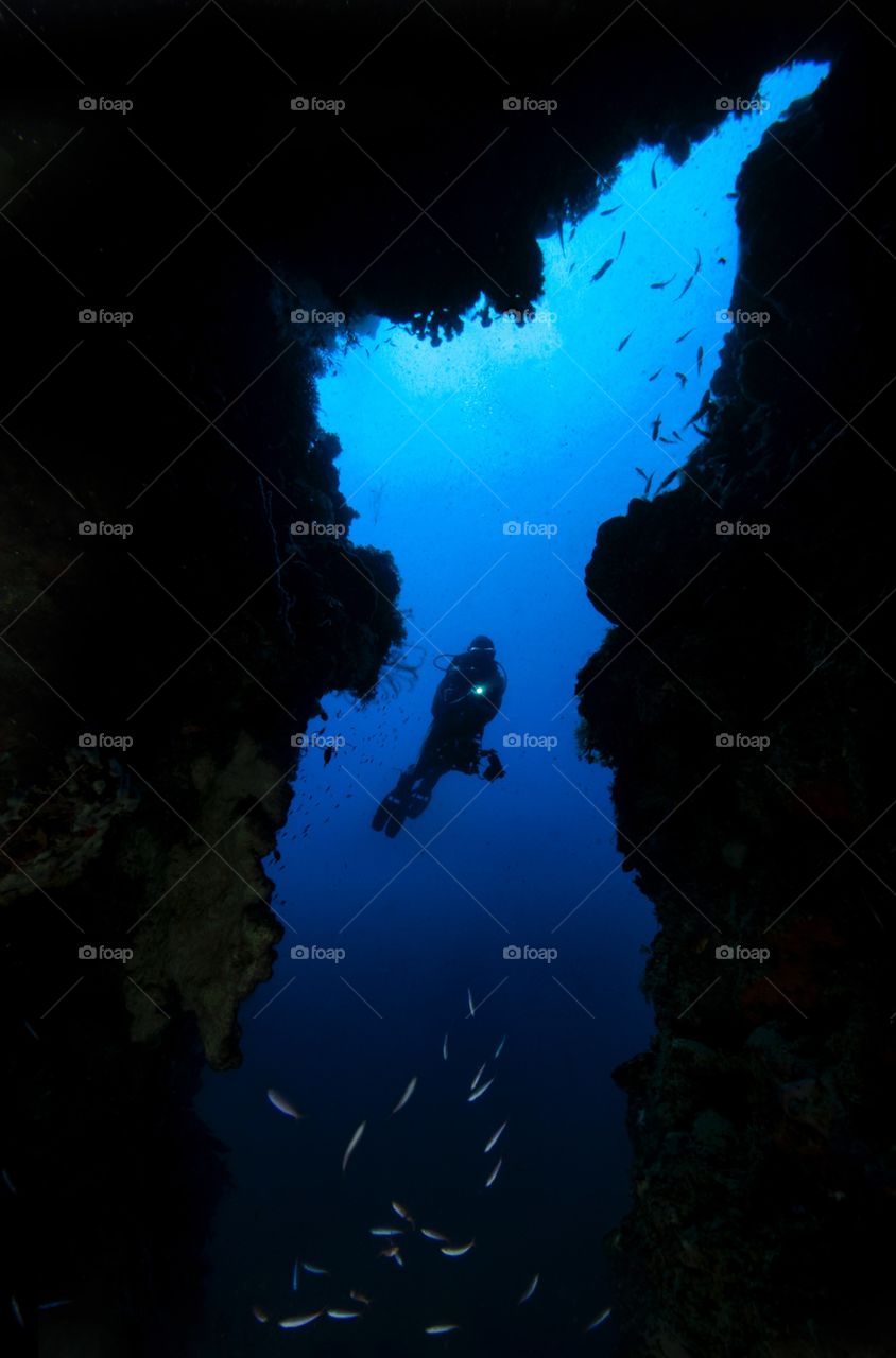 Cave diver. A diver exploring the cave at 36 meters depth. 