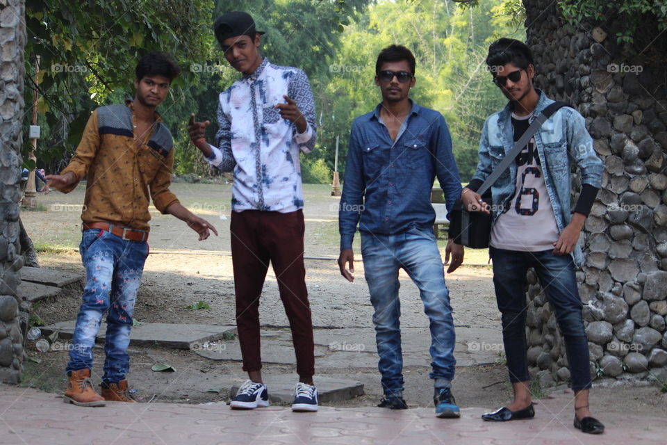 Group of young male friends standing at park